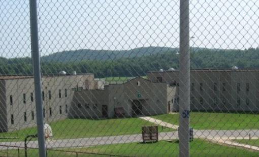 low concrete prison building in TN behind a chainlink fence